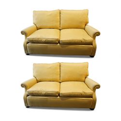 Pair of mid-20th century traditional two seat sofas, loose cushioned seat and back upholst...