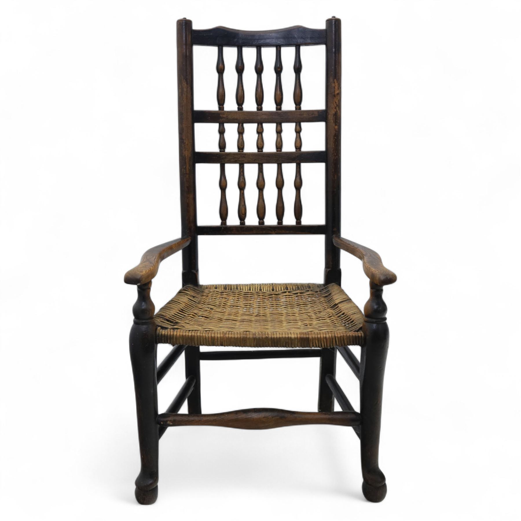 19th century country elm spindle back armchair, shaped cresting rail over two rows of turned spindles, shaped open arms over rush seat, on front turned supports, joined by stretchers 