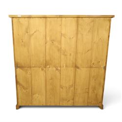 Indigo Furniture - large rustic oak open bookcase, with four adjustable shelves, above a plinth base 