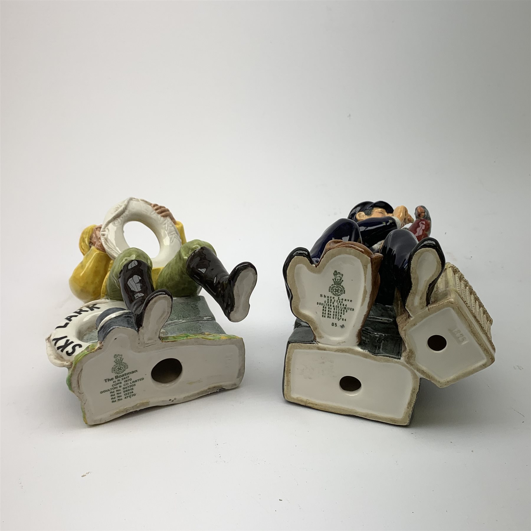 Two Royal Doulton figurines,  The Boatman HN2417, and Shore Leave HN2254, each with green printed mark beneath.