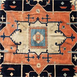 Exceptionally large Northwestern Persian Heriz, hand-knotted carpet, madder red field with a bold stepped medallion in indigo and ivory, and light blue spandrels within a dark indigo border of rosettes and angular vine motifs 




