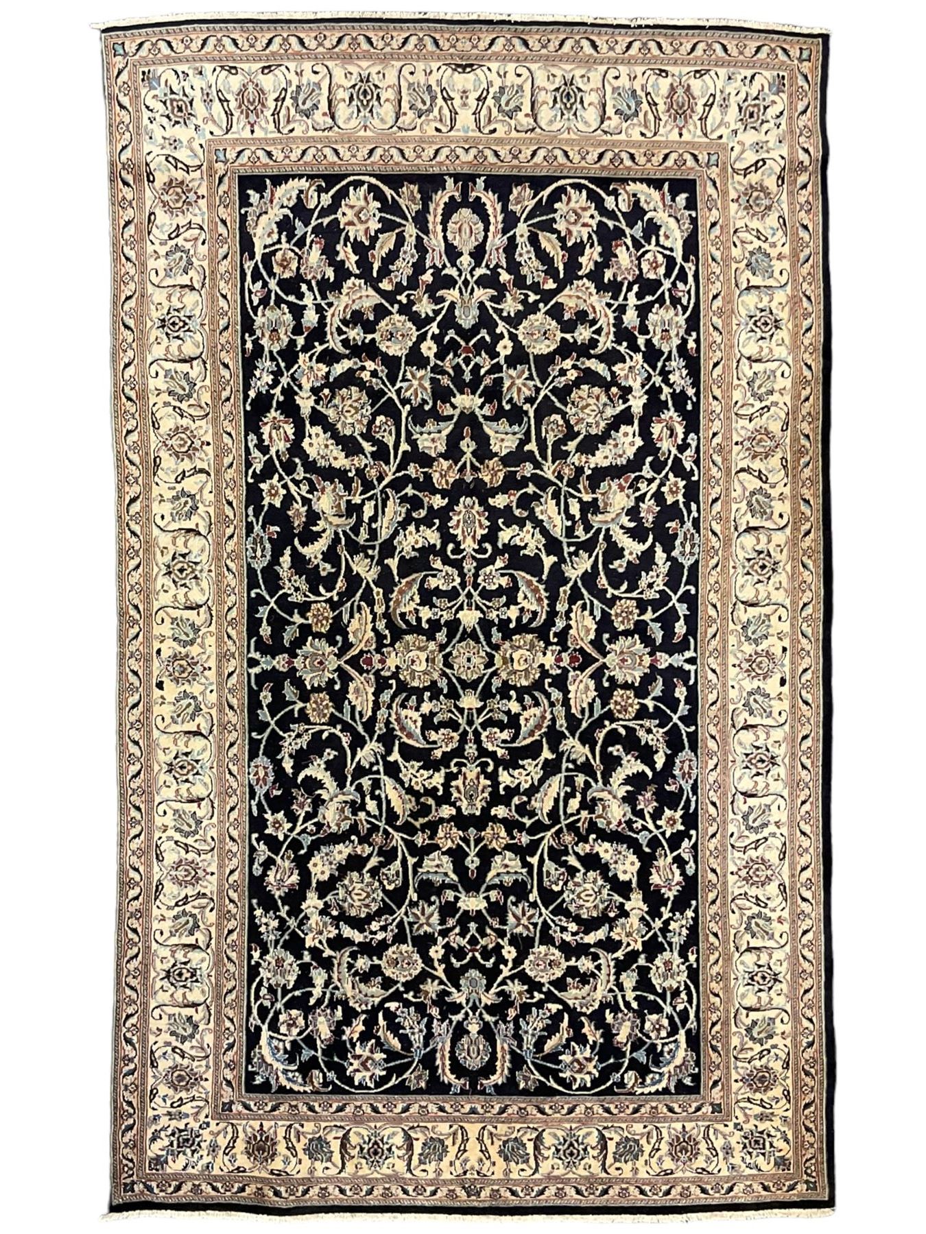 Central Persian part silk indigo ground Nain carpet, the field decorated with interlacing leafy branches and stylised plant motifs, scrolling design border within guard stripes 