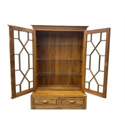 Acorn Industries - Georgian design yew bookcase on cupboard, fitted with two astragal glazed doors enclosing three glass shelves, over two drawers and cupboards, carved acorn signature to side, by Alan Grainger of Brandsby