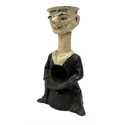 Early 20th Century painted cast iron 'Tough Nut' table top percussion nutcracker in the form of a sailor seated on lobster pot