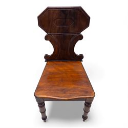 Pair of 19th century mahogany hall chairs, each with shaped octagonal backrest featuring a recessed cartouche panel, serpentine supports and moulded seat, raised on turned front legs