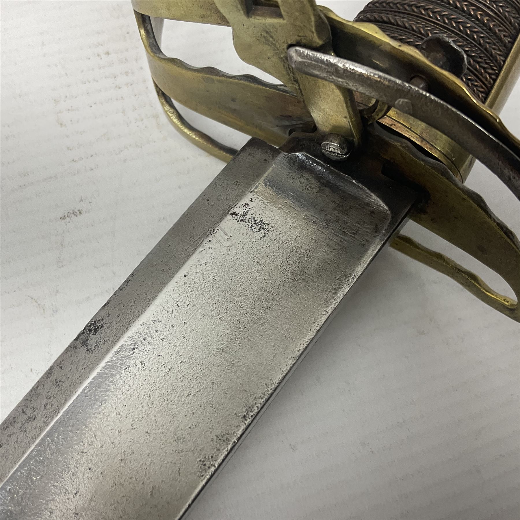 Late 18th century French 1st Empire Troupe a Pied Petit Montmorency Branch Tournante officer's sword, with 72.5cm slightly curving fullered blade, pierced brass hilt with lockable swivelling bar, fully wire-bound grip with lion head pommel, L88cm overall (no scabbard)