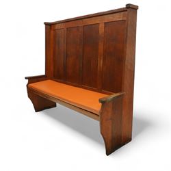 Sid Pollard of Thirsk – late 20th century adzed oak settle, tall panelled back with projecting top rail, shaped arms and tan upholstered drop-in seat, raised on chamfered end supports