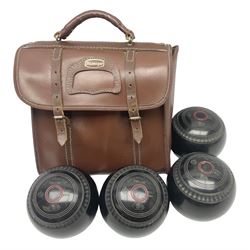 Eight Greenmaster lawn green bowling balls, comprising set of four size 5 examples and set of four size 4 examples, and faux leather carrying case