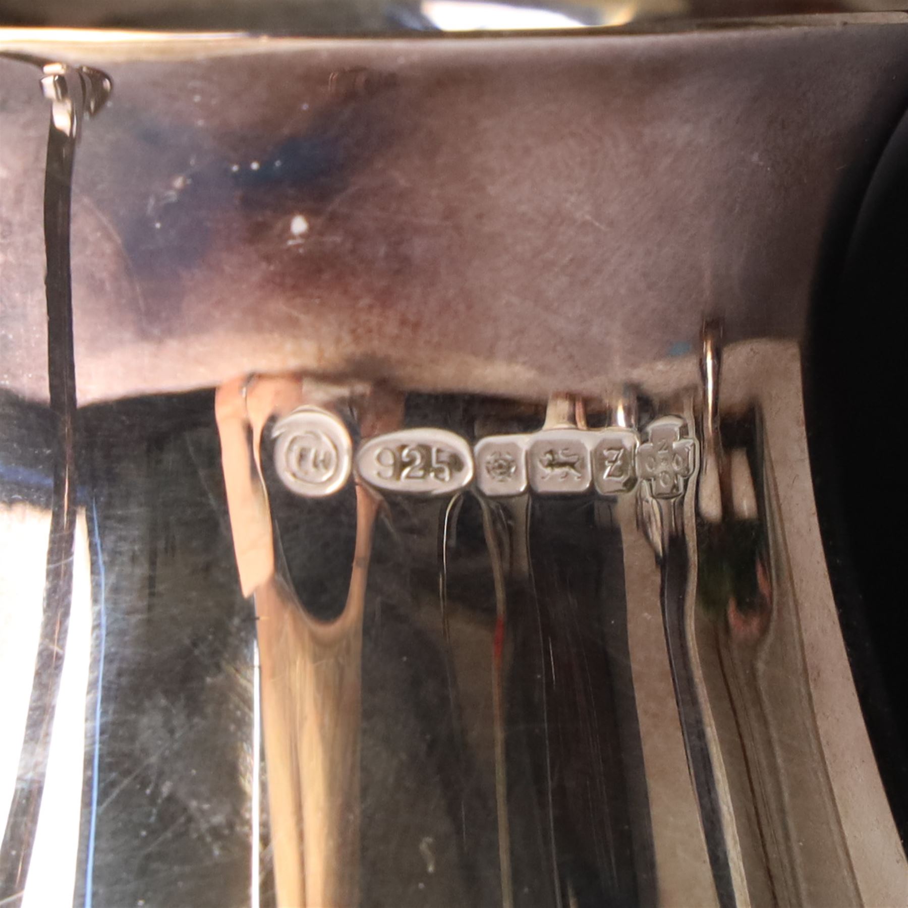 Georgian design silver cream jug with crimped rim and engraved with a crest London 1901 Maker Haseler Bros. and two smaller silver cream jugs (3)