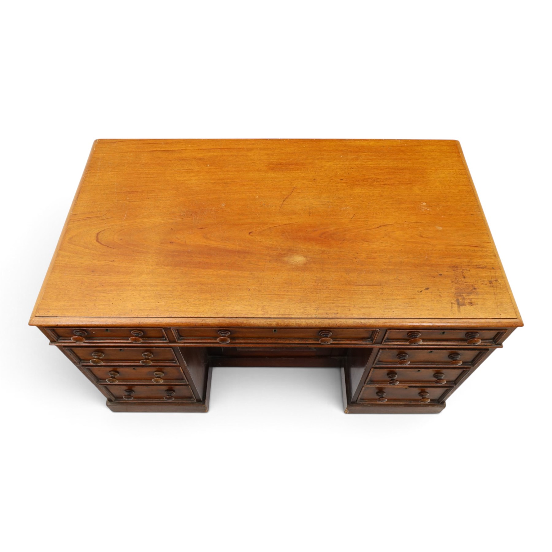 Victorian mahogany kneehole desk, rectangular top fitted with central frieze drawer over recessed cupboard, flanked by four graduating drawers to each side, on skirted base