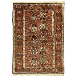 Turkish amber ground rug, the field decorated with five geometric medallions filled with contrasting segments, the guarded boarder with repeating geometric lozenges and shapes
