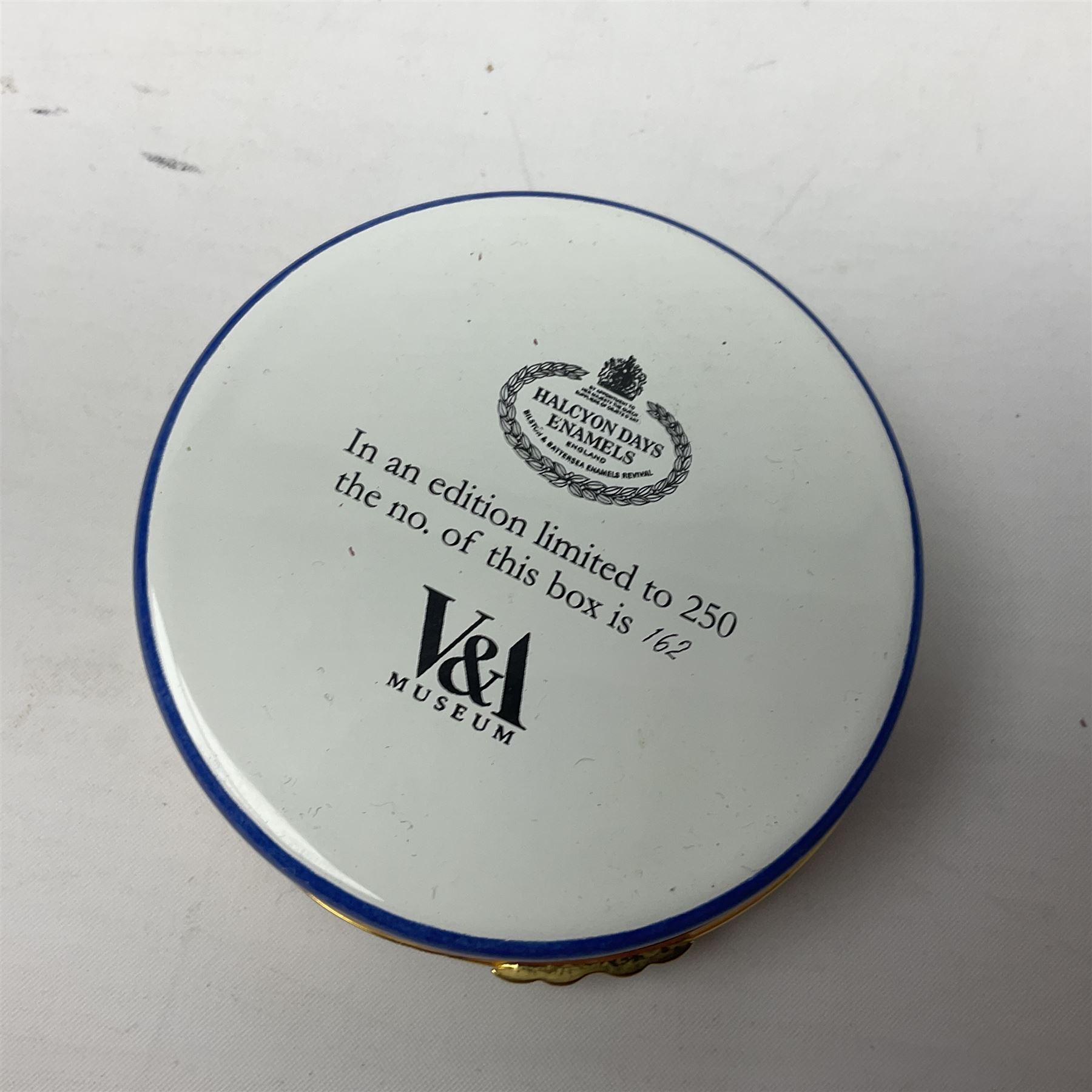 Halcyon Days bonbonniere, modelled as pink roses in a planter painted with a blue and white Japanese scene, together with five Halcyon Days enamel boxes, one a larger example depicting 'The Becket Casket' and four smaller boxes, including The 1993 Easter Egg, Happy Birthday and Statue of Liberty examples, all boxed, Becket Casket D8cm