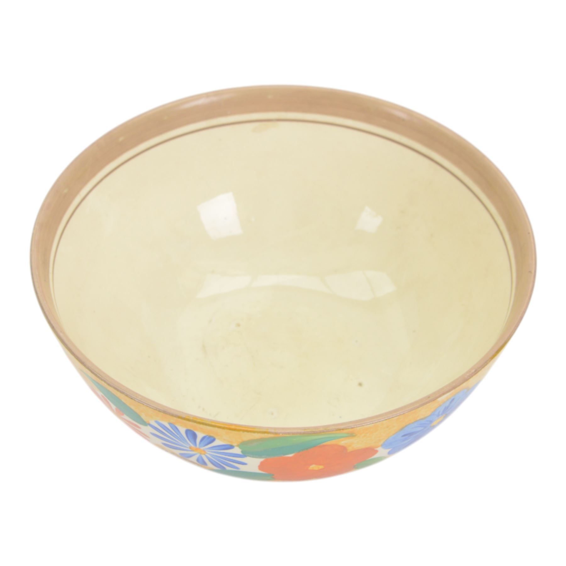 1930s Clarice Cliff Bizarre for Newport Pottery bowl, decorated in the Canterbury Bells pattern, the exterior painted with stylised flowers in blue, yellow and orange amongst foliage upon a brown and yellow Cafe au Lait stippled ground, with black printed mark beneath, D18cm