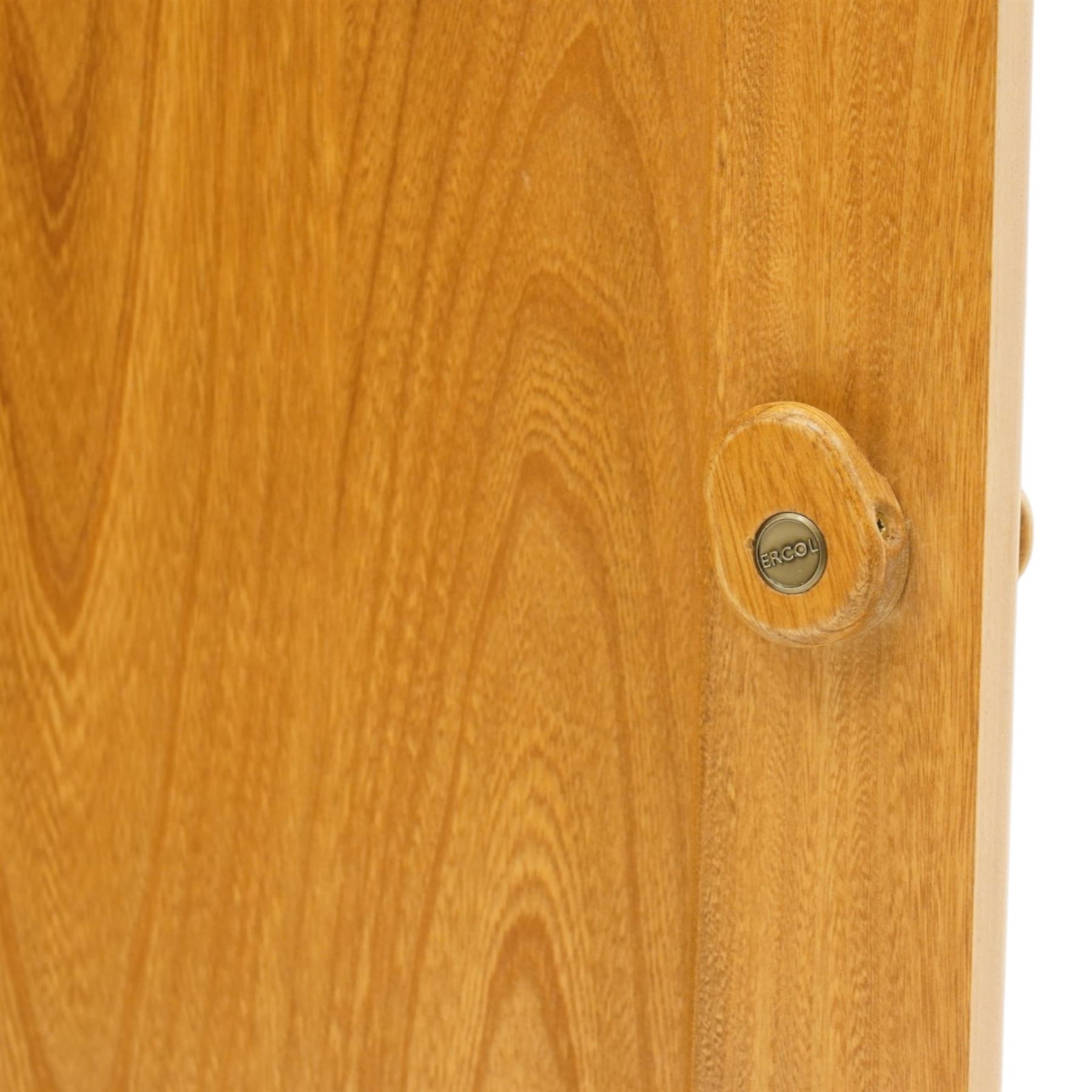 Ercol - elm corner display cabinet, Model 3856. Glazed upper section with glass door enclosing two glass shelves and interior light, above panel cupboard door, with rounded uprights and circular turned handles, on plinth base