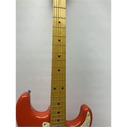 Japanese Squier Fender 'Hank Marvin' Stratocaster electric guitar, c1992, in Fiesta red with tremolo arm and facsimile signature decal; serial no.L037281, L98cm; in hard carrying case.