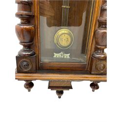 Small Spring driven German wall clock in a mahogany case with turned columns and pendants, with a fully glazed door and gridiron pendulum, ivorine dial with Roman numerals and gothic steel hands, eight day movement striking the hours on a gong.