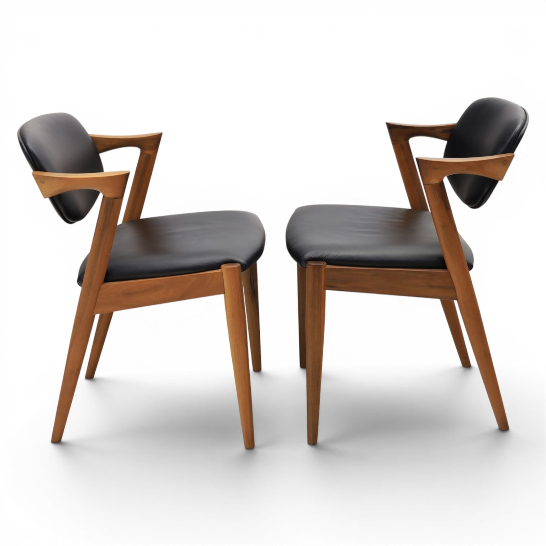 Kai Kristiansen (Danish c.1929-2022) - Pair of mid-20th century teak elbow chairs upholstered in black leatherette