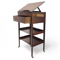 George III mahogany and boxwood-strung drawing table, the rectangular sloping reading surface with rest and oak stay, above a blind drawer and a drawer fitted with brass ring handles, side with pull-out candleholder and inkwell compartment, raised on square-section tapered legs with brass box castors united by two galleried under tiers