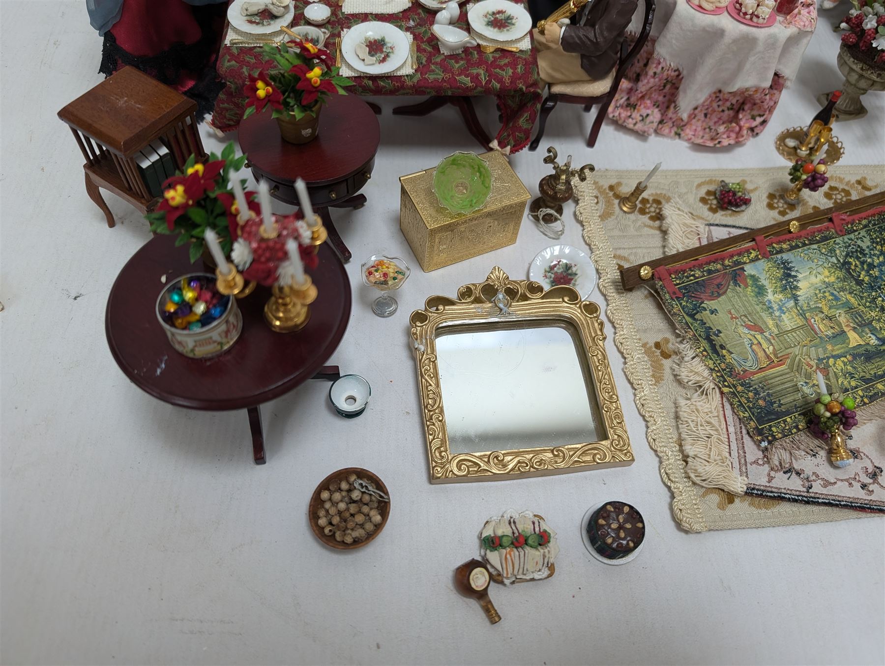 Dolls house living room and dining room furniture, including arm chairs, desk, fireplaces, dressers, tables, eight figures and a large collection of predominantly Christmas themed food, accessories and decorations