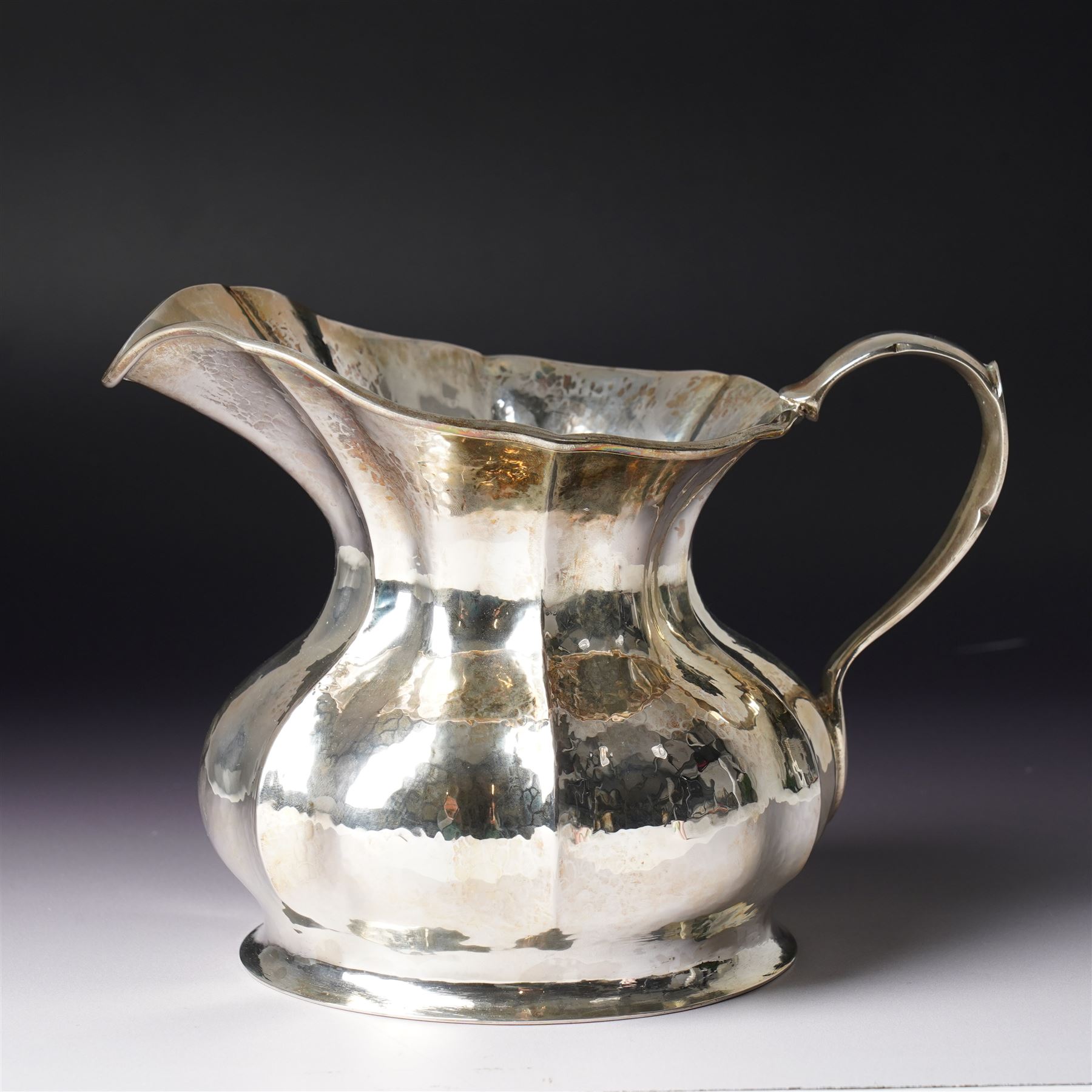 Italian 800 standard planished silver water jug of panel sided design with scroll handle  H14.5cm retailers label Bello di Frison, Padova