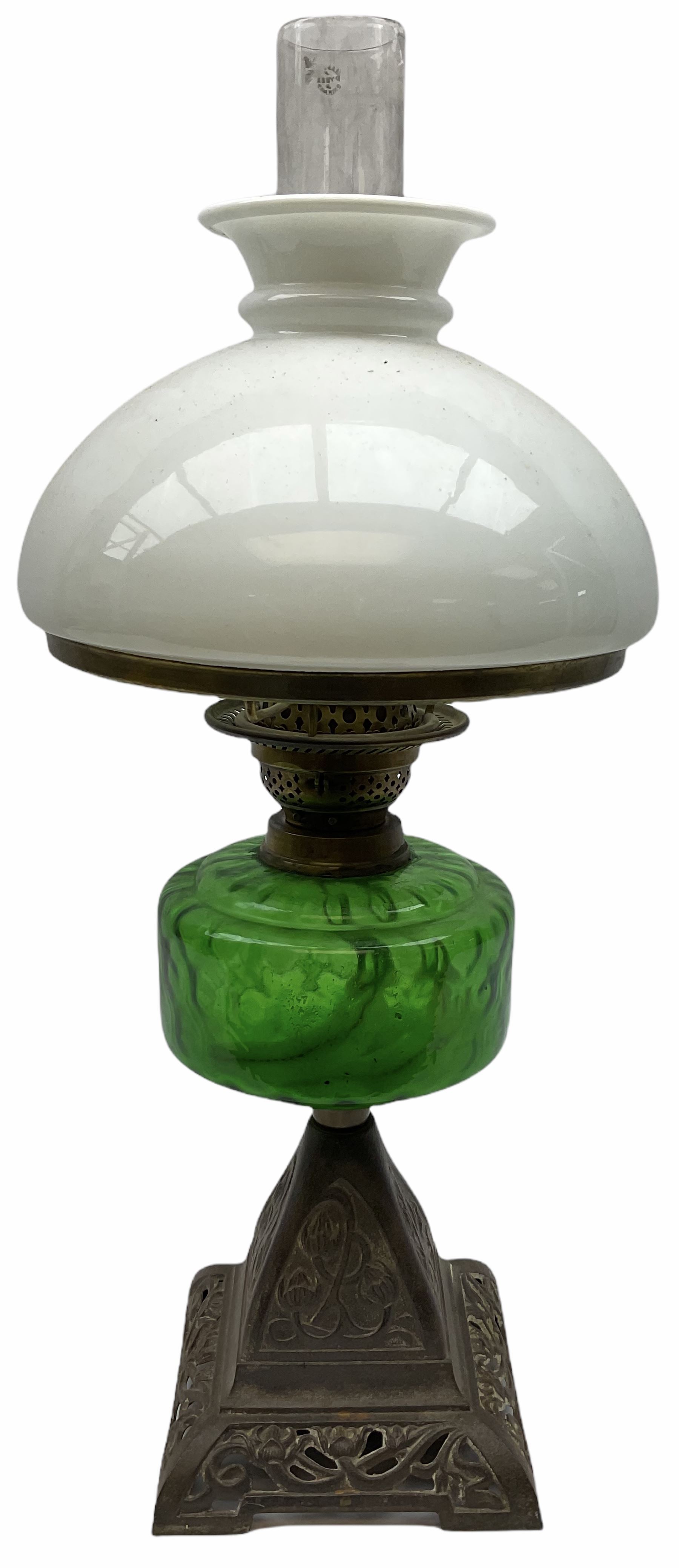 Late Victorian oil lamp, the cast metal base decorated with foliate tendrils, supporting a green glass reservoir, and opaque glass shade and clear class chimney, H60cm. 