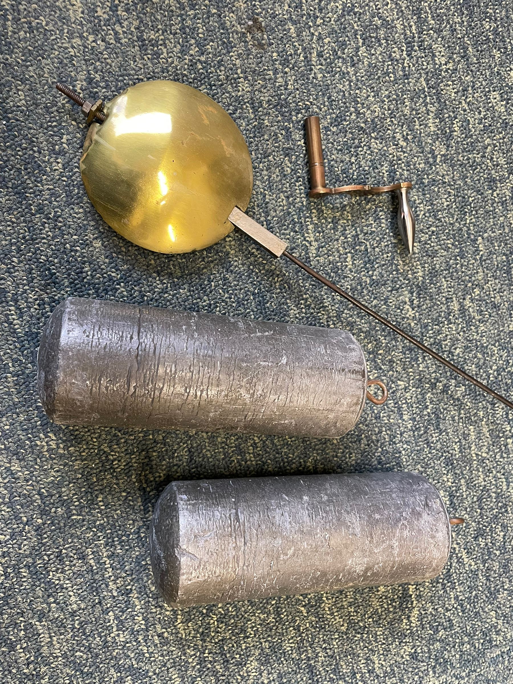 William Gostling of Diss  (Norfolk)-  Late 18th century 8-day oak longcase clock c1780-90, break arch top with scalloped cresting and three brass finials, glazed break arch hood door flanked by turned pilasters with brass capitals, trunk with a long trunk door and rounded top on a square plinth with an applied and shaped skirting, early painted Wilson of Birmingham dial with Roman numerals and five minute Arabic's, matching steel hands and second pointer, arched square ended calendar aperture with date disc behind, floral spandrels within gesso borders and a painted rocking automaton representing Mercury to the break arch, dial pinned via a false plate to a weight driven rack striking movement with a recoil anchor escapement, striking the hours on a cast bell. With pendulum weights and key. 
William Gostling (II) is recorded as working in Diss from 1774 to 1797, succeeded by widow Anne and son George . The dial of this clock is illustrated and discussed in detail in M.F. Tennants book 