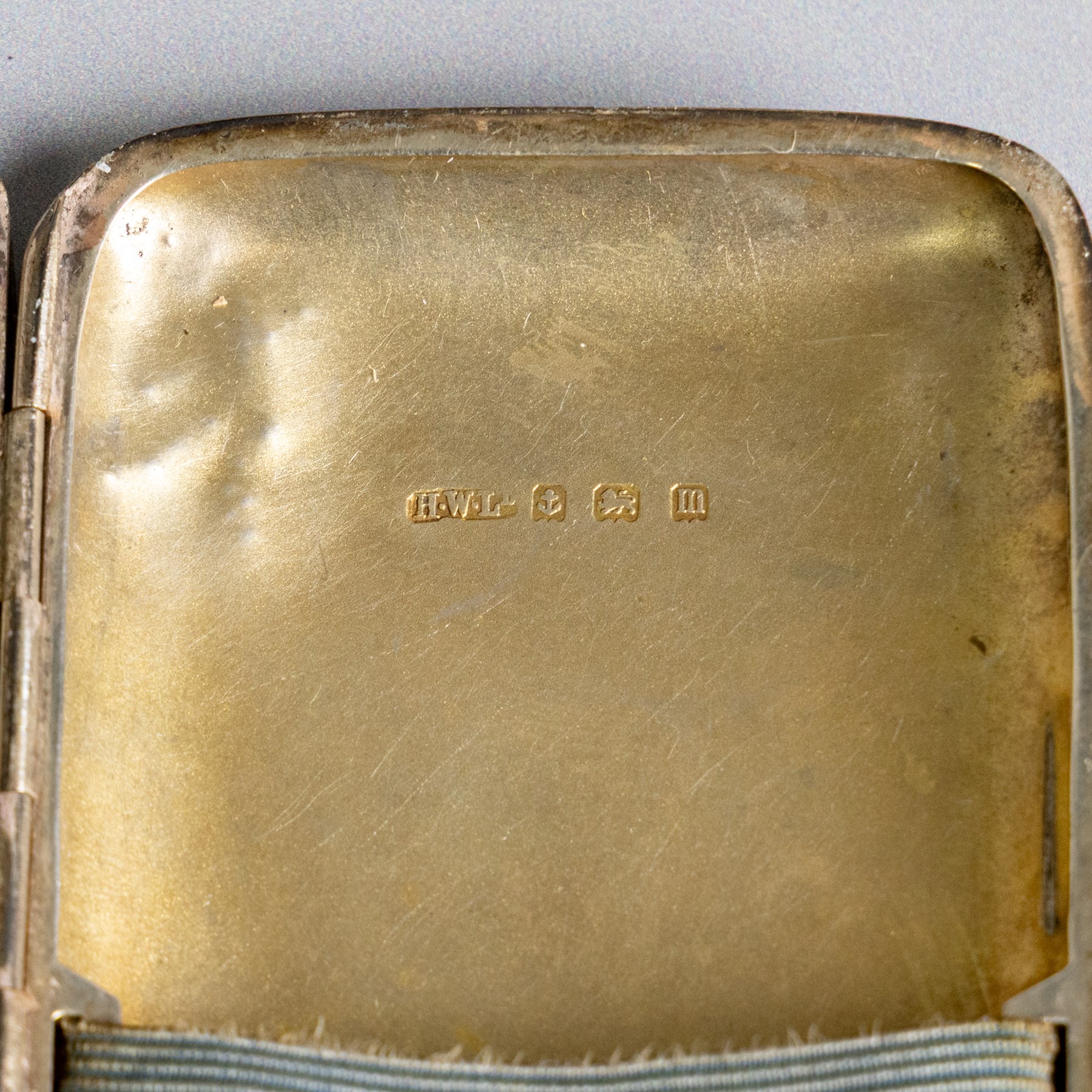 Early 20th century silver coin purse, with floral decoration and finger chain, hallmarked together with an early 20th century cigarette case,  with engraved initials, hallmarked and a silver filigree cigarette case