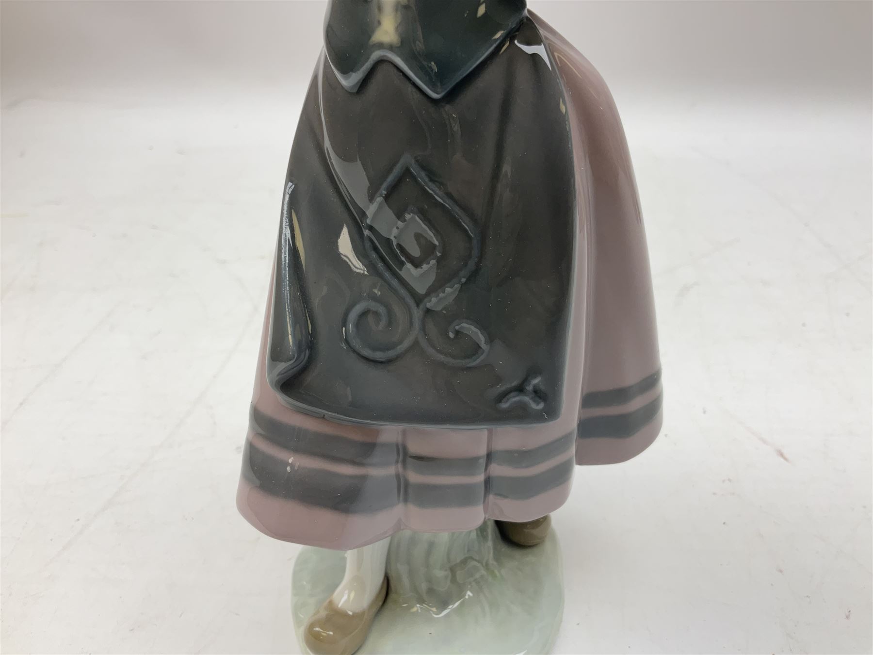 Three Lladro figures, comprising Pondering, no 5173, Nostalgia, no 5071 and Nature's Bounty, no 1417, all with original boxes, largest example H27cm