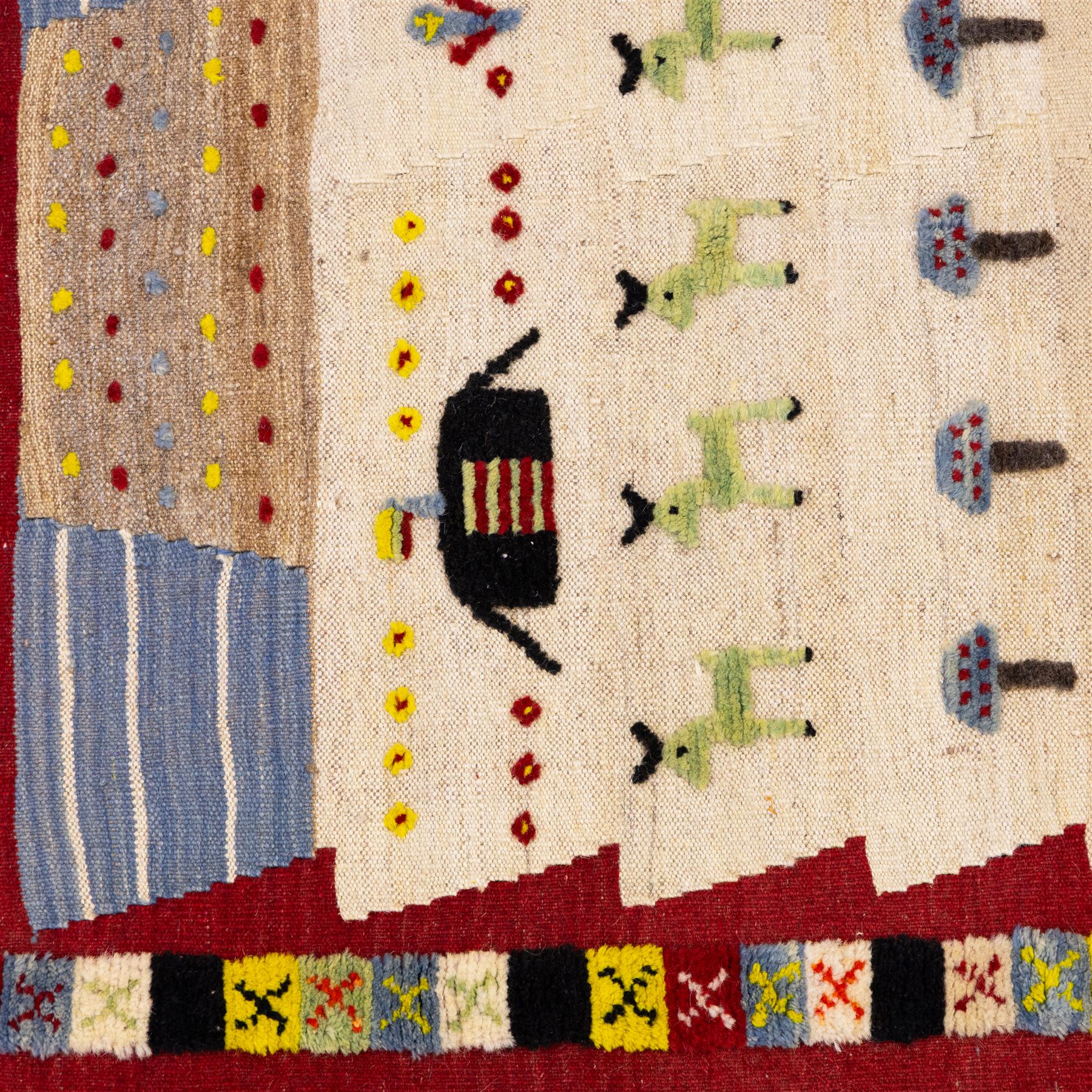 South West Persian Qashqai pictorial flatweave kilim, ivory field decorated with rows of stylized animals, bird and tree motifs applied in raised wool pile against a flat-woven ground, arranged in horizontal bands beneath a simple geometric panel enclosed by a broad red ground border with polychromed geometric devices 