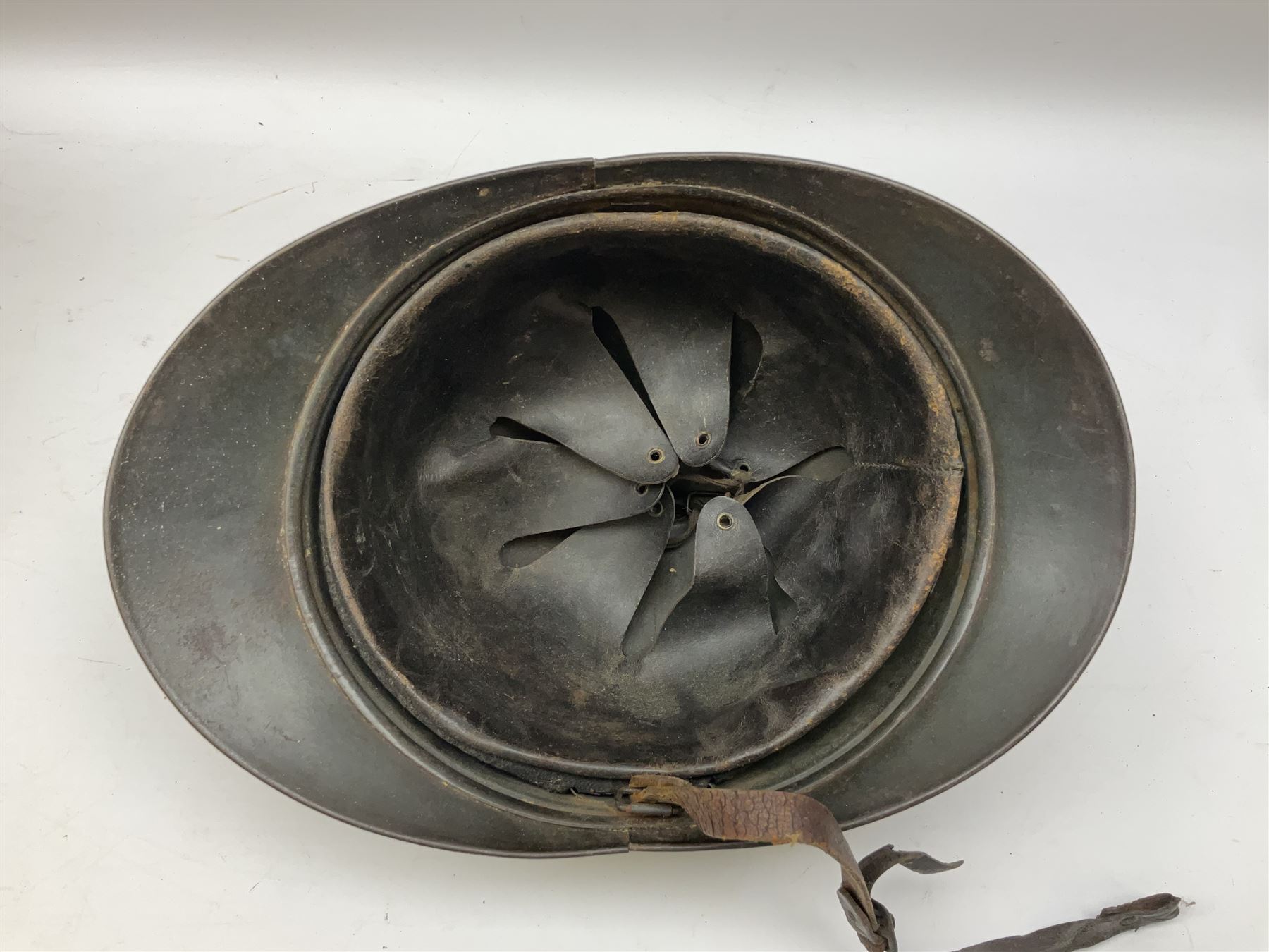 WW2 French M-26 Adrian Pattern Steel Helmet, original olive drab paint finish; flaming grenade badge to the front signifying issue to an Infantry regiment; original leather liner and leather chinstrap; and WW2 Dutch steel helmet with liner and chin strap (2)