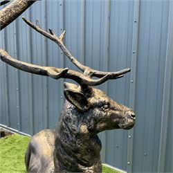 A pair of bronzed cast iron life-size garden or indoor Stags, oval plinth base - THIS LOT IS TO BE COLLECTED BY APPOINTMENT FROM DUGGLEBY STORAGE, GREAT HILL, EASTFIELD, SCARBOROUGH, YO11 3TX