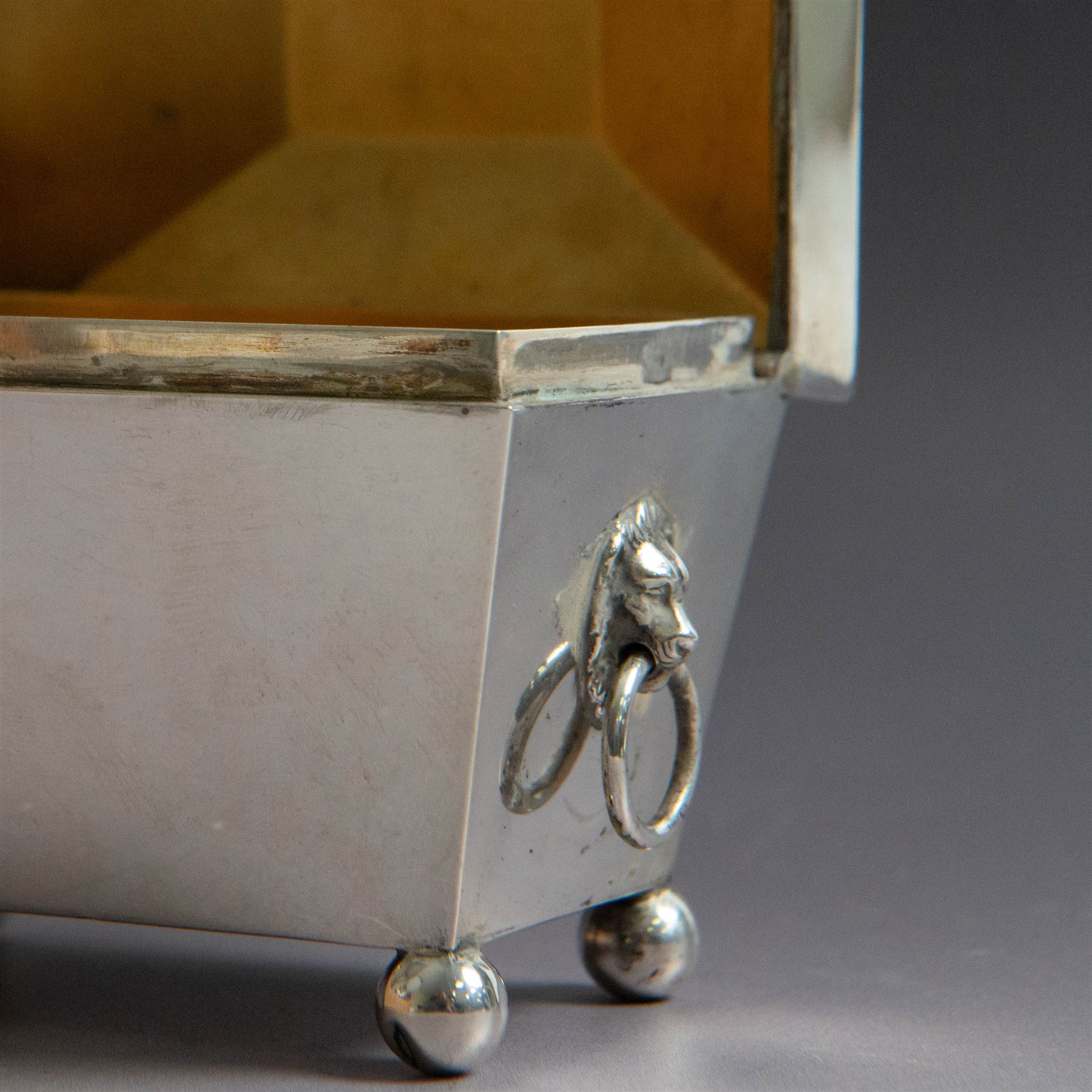 Early 20th century silver tea caddy, of sarcophagus form with twin lion mask mounted loop handles, upon four bun feet, hallmarked William Hutton & Sons Ltd, Birmingham 1913, H8cm, W9cm