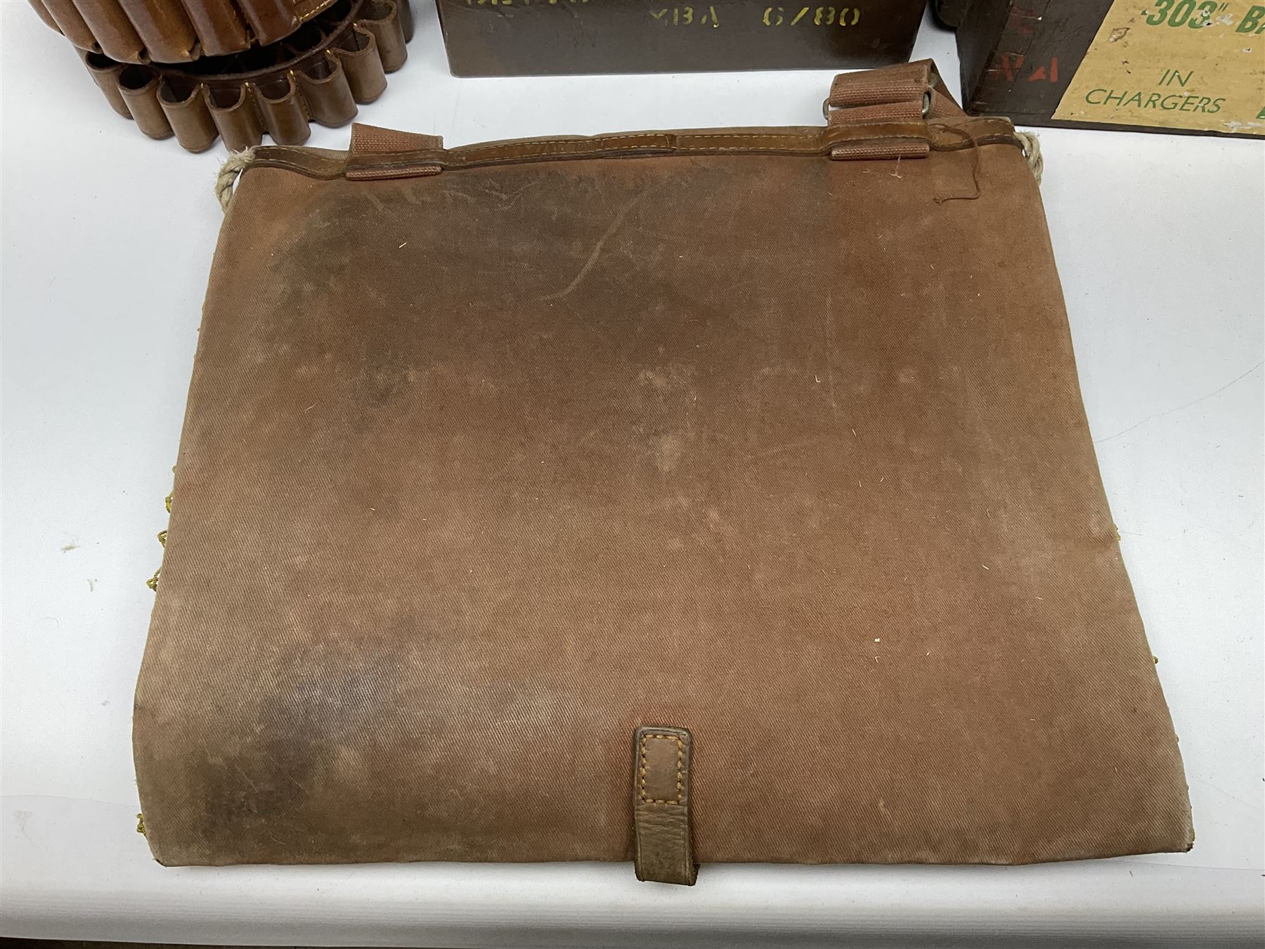 Miscellaneous shooting accessories - W.J. Bowman & Sons clay pigeon launcher; two leather cartridge belts; three cartridge bags; two canvas/leather game bags; and two metal/wooden cartridge boxes