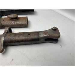 British No 7 MKI knife bayonet with 20cm single edged fullered clipped point blade;  blackened steel, large muzzle ring cross-guard; blackened swivelling pommel marked 'F5H'; red Tufnol composite grips; in blackened steel scabbard L33cm overall; British Pattern 1888 bayonet with scabbard; and German Ersatz bayonet with scabbard (3)