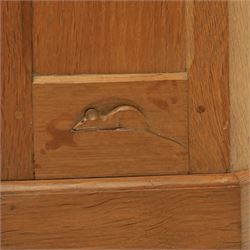 Mouseman - oak floor standing corner cabinet, scalloped cornice above a leaded glass cabinet, blackened metal hinges and latches, with carved mouse by the workshop of Robert Thompson of Kilburn