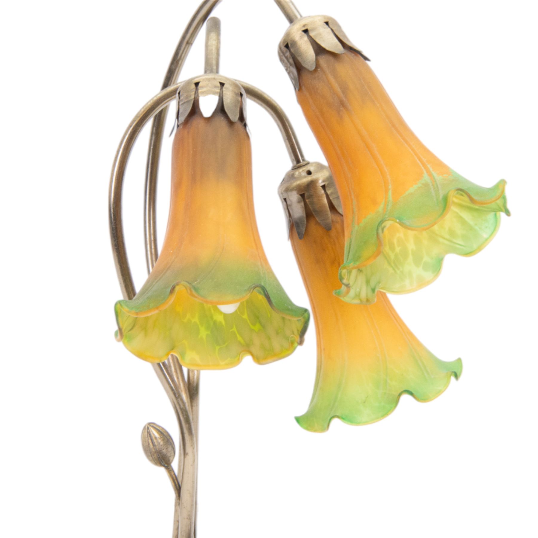 Art Nouveau Tiffany style table lamp, the bronzed base modelled as lily pads leading to tendrils and three branches supporting green and yellow glass lily flower shades, H42cm