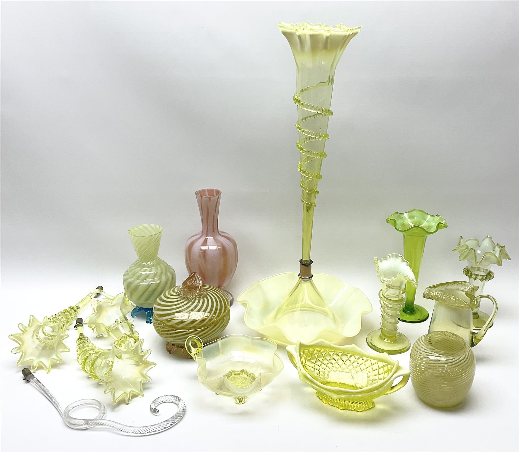 A group of Victorian and later Vaseline glass, to include part epergne, two vases with crimped rims and trailed decoration, a uranium glass vase, lemon Vaseline glass twin handled bowl, etc. 