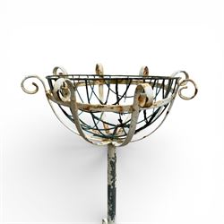 Two plant stands in a weathered white finish with wire baskets