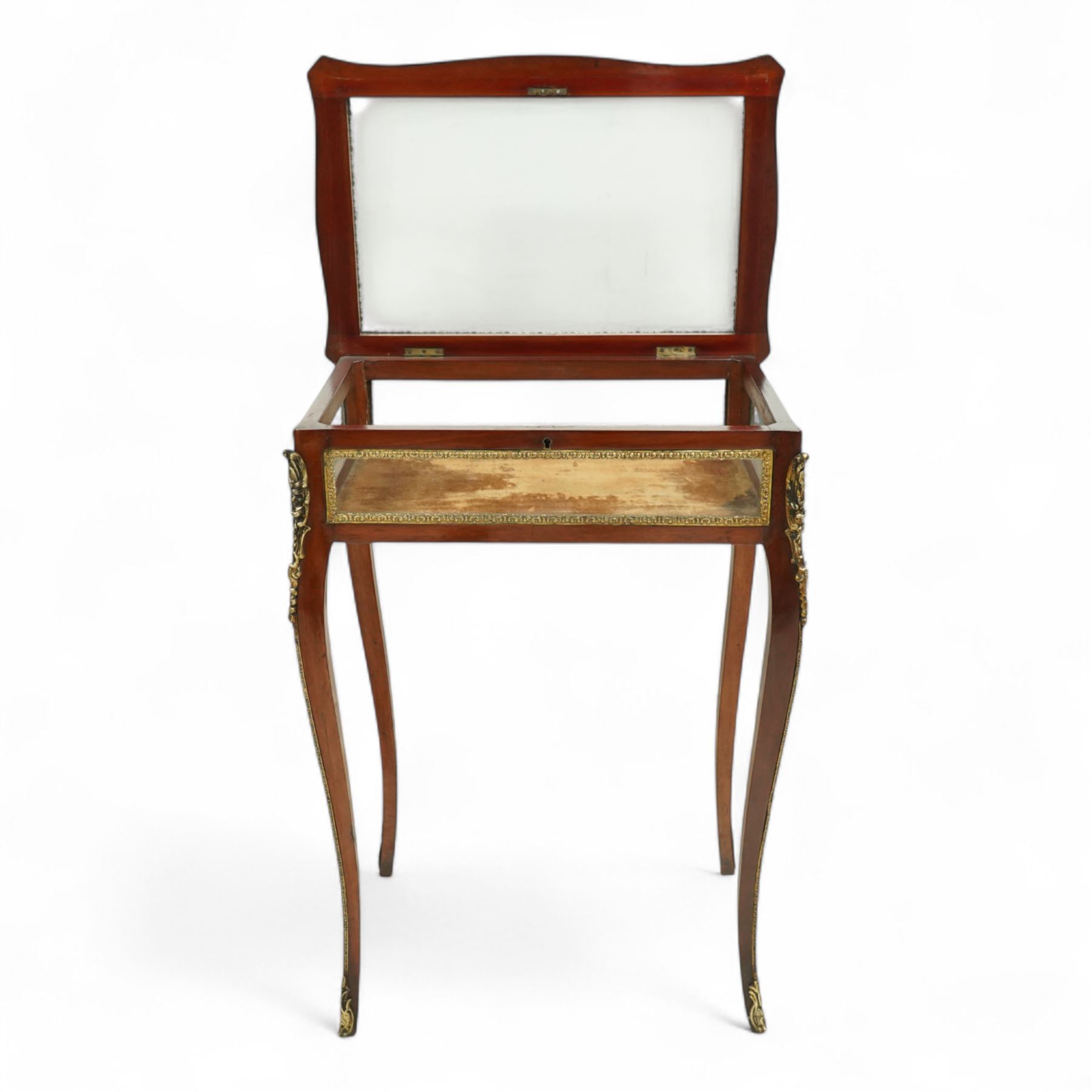 19th century, Louis XV style, bronze mounted bijouterie table, the hinged rectangular bevelled glass top with gilt bronze foliate beading, side glass panels  and plush-lined velvet interior, raised on cabriole legs, with gilt bronze masks and sabots