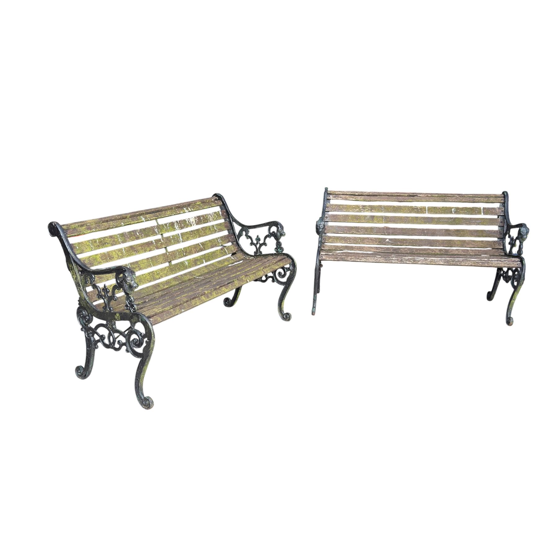 Pair of Victorian Revival Coalbrookdale design 'Dog and Serpent' pattern benches with slatted seats, the cast iron end supports of pierced and scrolling design with dog mask arm terminals