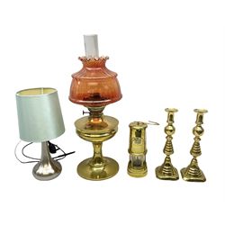 Cymru Welsh brass and glass miner's lamp with raised plaque, brass oil lamp with coral glass shade, pair brass candlesticks and brushed metal lamp with blue shade