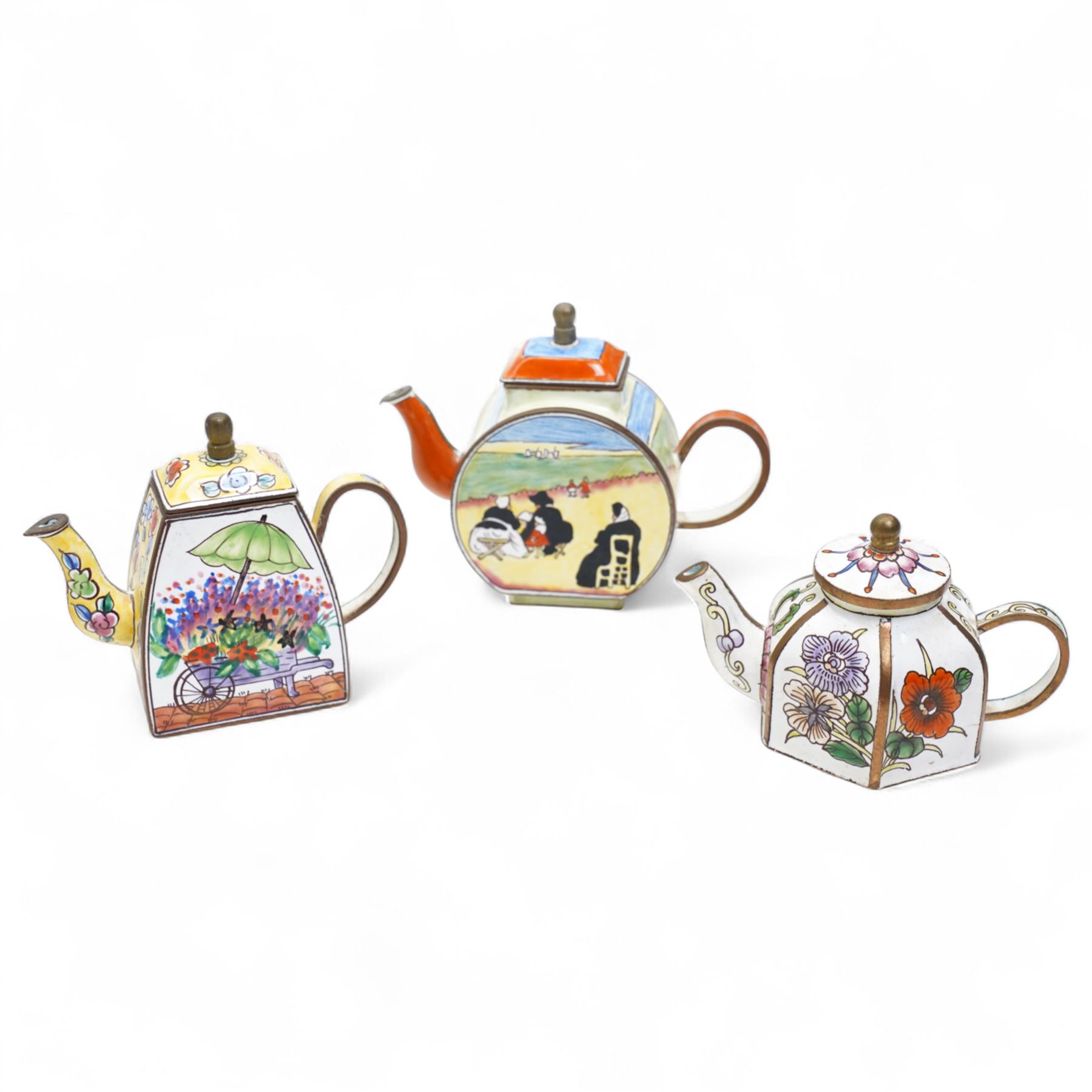 Ten Charlotte de Vita for Trade plus Aid miniature hand-painted enamel teapots, designs comprising The Kiss, Peter Rabbit, Dancing Girls, Catkins etc; and one other painted enamel teapot, largest H9.5cm (11)