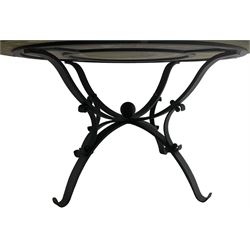 Granite and wrought metal garden table, circular granite top inlaid with geometric design mosaic band, on scrolled work wrought metal base with four splayed supports 