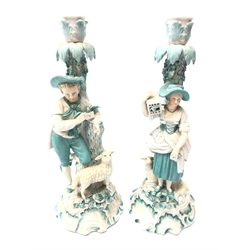  Pair 19th century porcelain candlesticks modelled as a male and female leaning against a tree amongst animals, possibly Milan San Cristoforo, H27cm   