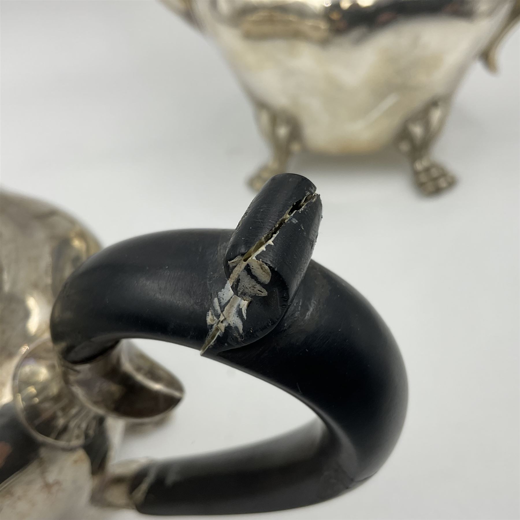 Five piece Edwardian silver tea service, comprising teapot and coffee pot, each with ebonised scroll handle, tea caddy with hinged cover, twin handled open sucrier, and milk jug, each of rounded bombe form, upon four paw feet, hallmarked William Adams Ltd, Birmingham 1904 and 1905, coffee pot H26cm
