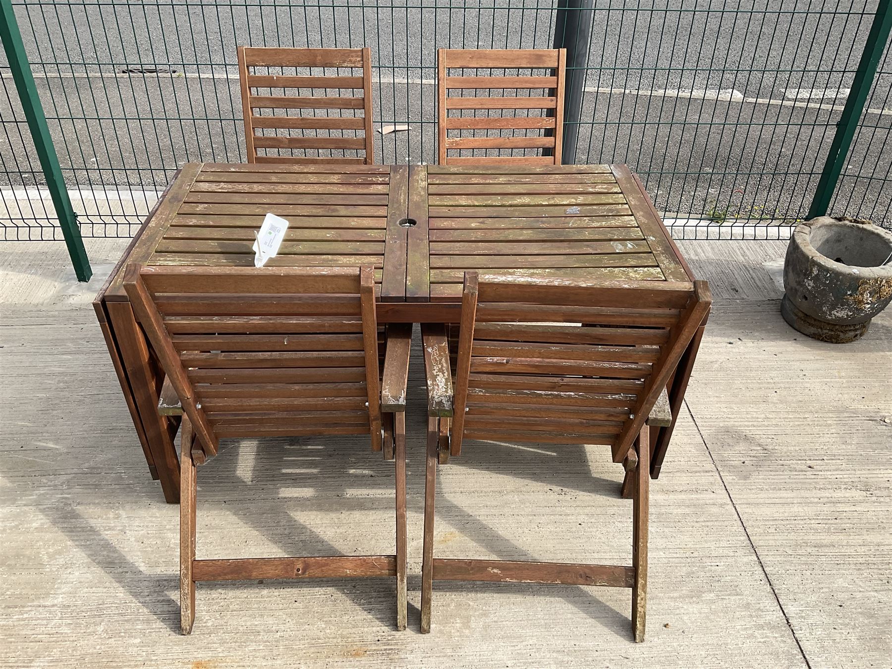 Rectangular teak drop leaf garden table, and four slatted armchairs