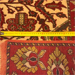 Persian Kerman hand-knotted rug, ivory and crimson ground, central medallion surrounded  by a floral foliate pattern, main border with repeating design of floral cartouches and palmettes, and narrow vine work guard border  