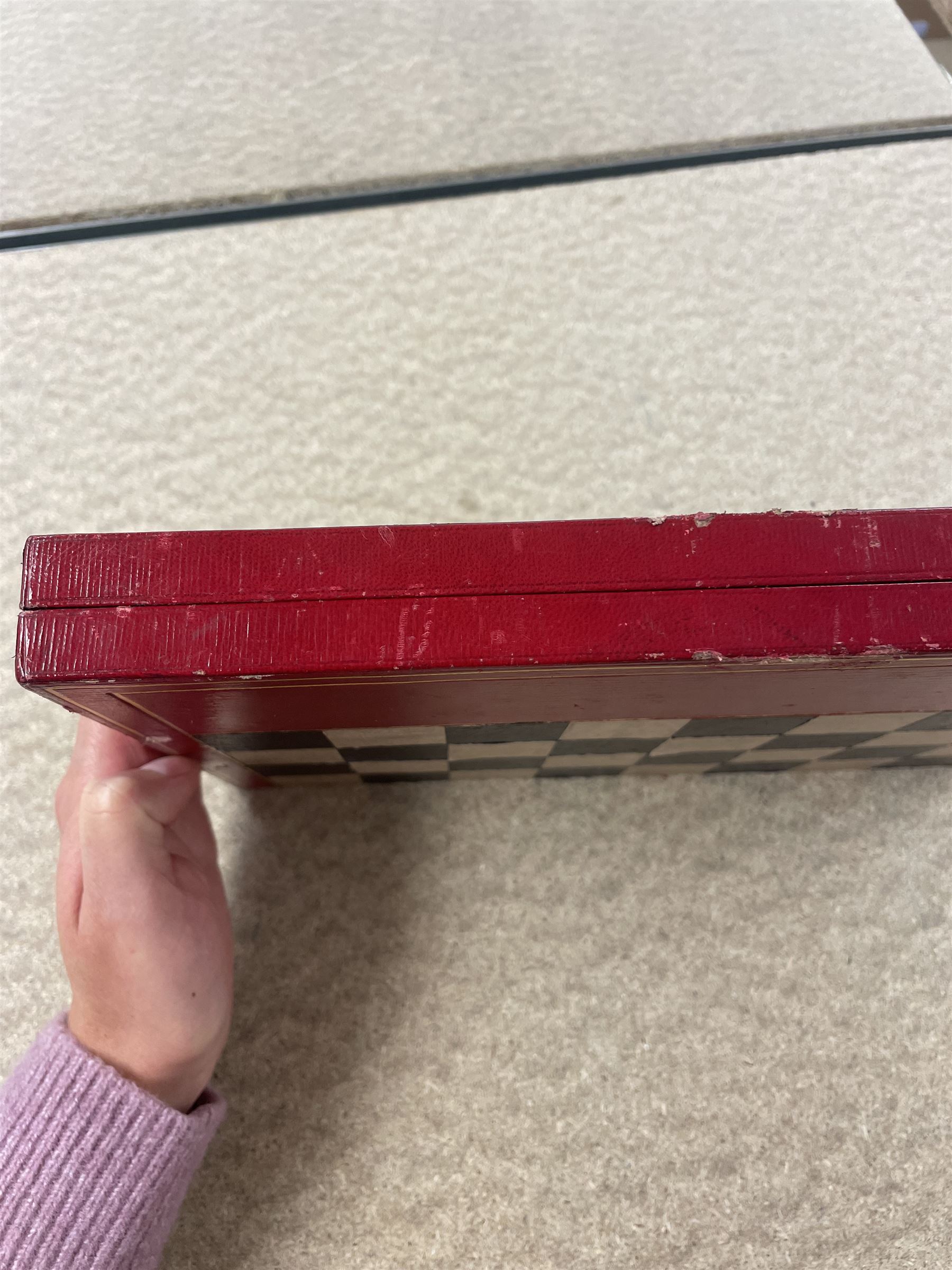 19th century walnut and brass bound games compendium box, painted to enhance the grain, of rectangular form, the hinged opening cover with rounded sides, central brass cartouche with engraved lion crest, and brass riveted straps, opening to reveal a red leather and blue silk lined compartmented interior, with fold-down games board, and lift-out tray containing playing cards, ebony turned dice towers, white and red stained bone draughts, and chess pieces, ivory dice, and ivory and ebony whist markers, and brass bezique board, cribbage board and markers, H15cm W32cm D24cm
This lot has been registered for sale under Section 10 of the APHA Ivory Act