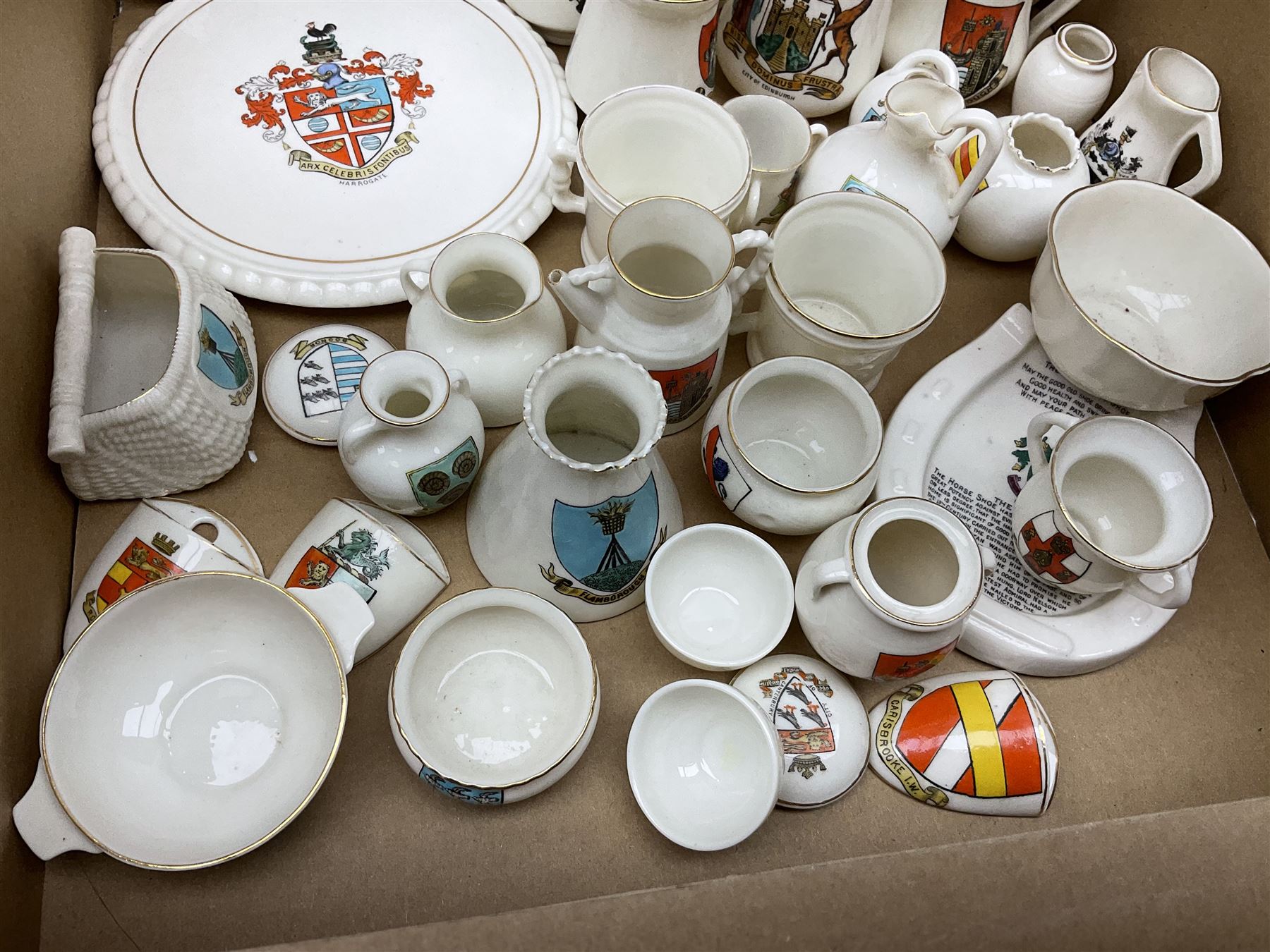 Collection of W H Goss crested ware, to include Yorkshire Roman Ewer, Scarborough ancient jug, salt and pepper shakers, Norwegian horse shaped beer bowl, The Old Horse Shoe, etc, together with five Shelley examples modelled as piano, boat, heart shaped box, etc, in two boxes 