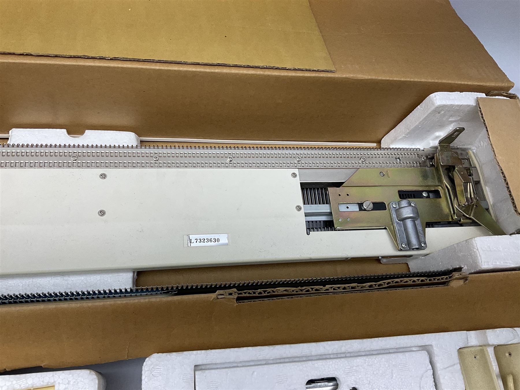  Brother cased knitting machine model KH-890 together with Brother Ribbing attachment model KH-850, knitting machine yarn cones in assorted colours, selection of knitting patterns etc
